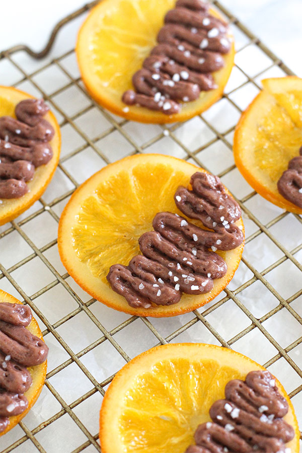 Candied orange slices with Simply Desserts sugar free chocolate pudding on a cooling rack